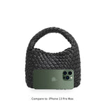 An iphone 13 pro size comparison image for a small hand woven vegan leather top handle bag.