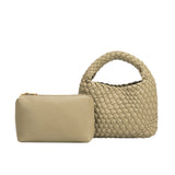 A small moss hand woven vegan leather top handle bag with a zip pouch.