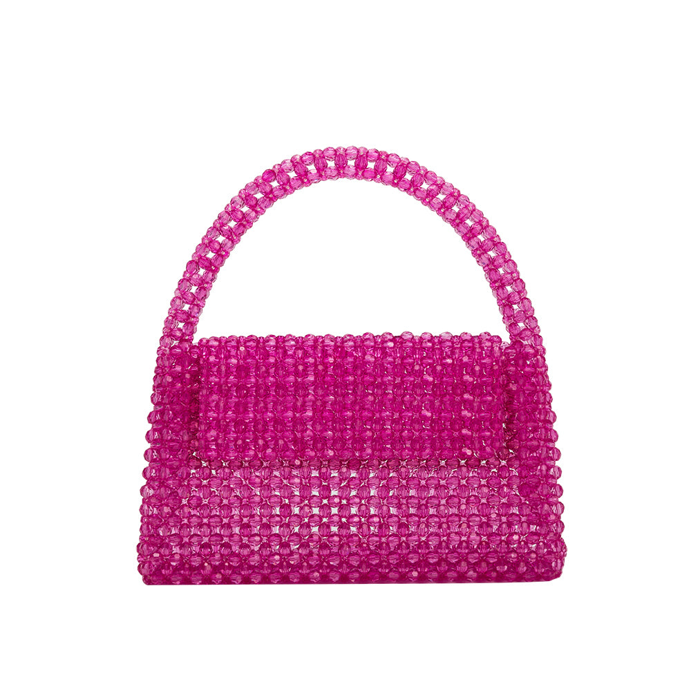 A small fuchsia crystal beaded top handle bag with a flap closure. 