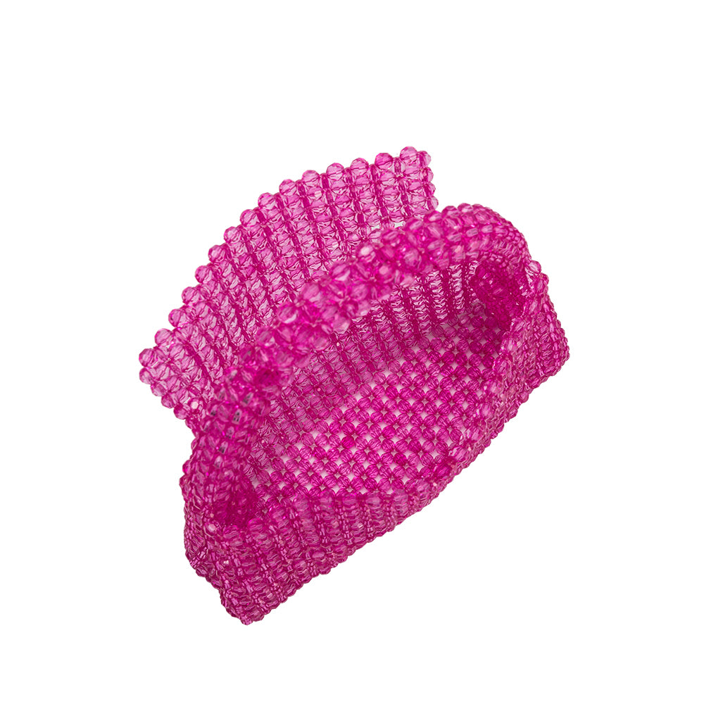 A small fuchsia crystal beaded top handle bag with a flap closure.