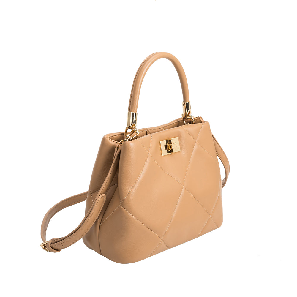 A camel crossbody bag with quilt pattern and gold clasps. 
