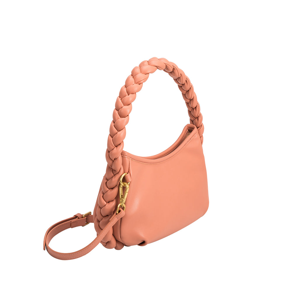 A small salmon recycled vegan leather top handle bag with a braided handle. 