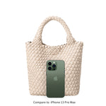 An iphone 13 pro size comparison for a small woven vegan leather tote bag with double handle. 