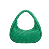 A green curved woven vegan leather shoulder bag.