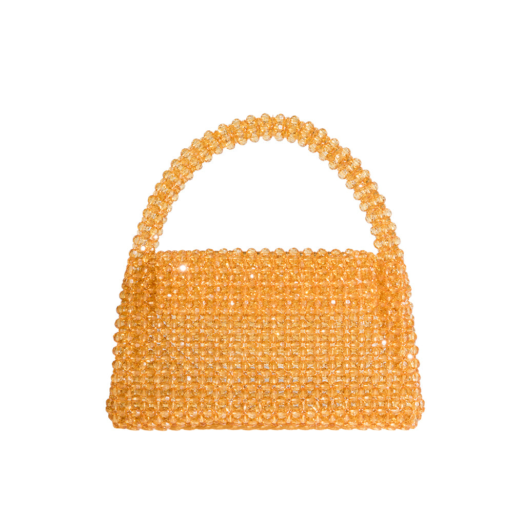 A small cirtrine crystal beaded top handle bag with a flap closure. 