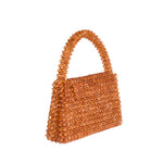 A small topaz crystal beaded top handle bag with a flap closure. 