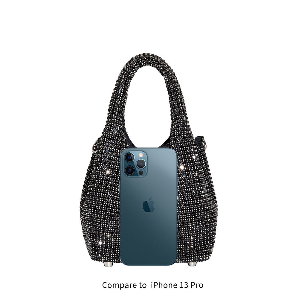 An iphone 13 pro size comparison image for a small crystal encrusted crossbody bag.