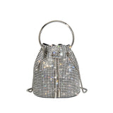 A small silver crystal drawstring ring top handle bag.