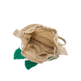 A small green straw drawstring crossbody bag with green pompoms