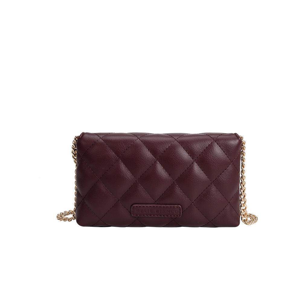 A small burgundy quilted vegan leather shoulder bag with gold M hardware. 