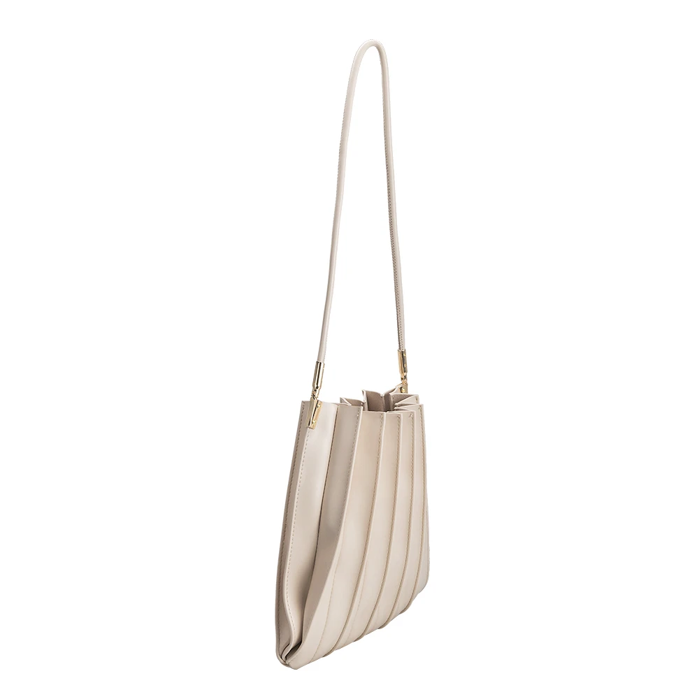A bone pleated vegan leather shoulder bag with gold clasps.  