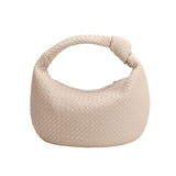 A bone recycled vegan leather shoulder bag with a knot. 