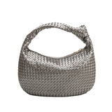 A pewter metallic recycled vegan leather shoulder bag with a knot. 