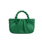 A small green recycled vegan leather crossbody bag with twisted handle. 