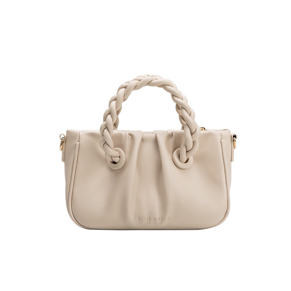 A small ivory recycled vegan leather crossbody bag with a twisted handle.