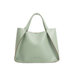 A large mint recycled vegan leather tote bag with a wrapped handle. 