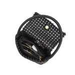 An inside view image for a small crocheted vegan leather shoulder bag with a phone, makeup, and sunglasses inside. 