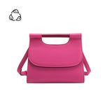 A small fuchsia square vegan leather crossbody bag with a wooden handle. 
