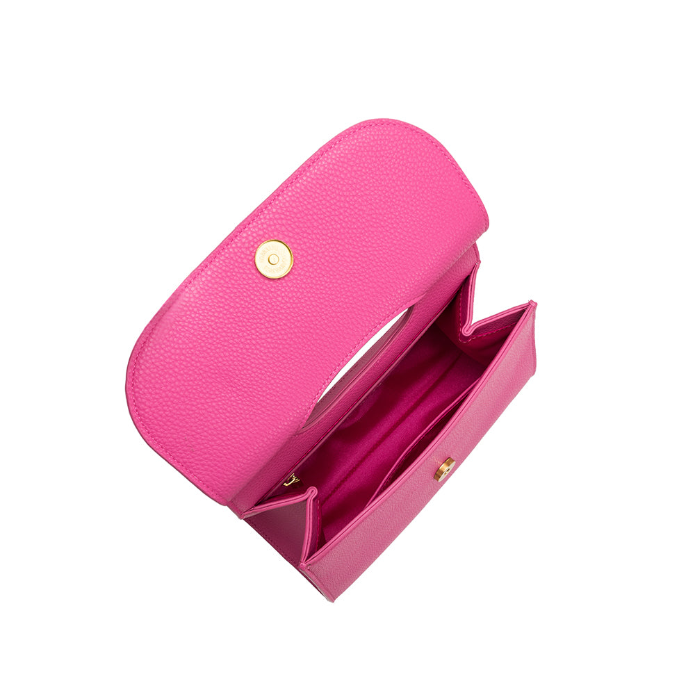 A small fuchsia square shaped vegan leather crossbody bag with a wooden handle. 